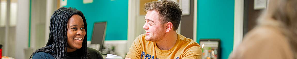 Two students sat at a table talking