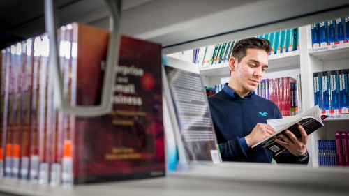 A student reading in the library.